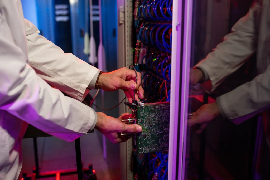 Technician inserting blade server into a cabinet for secure IT asset disposition and electronics recycling in Avondale, Techbros