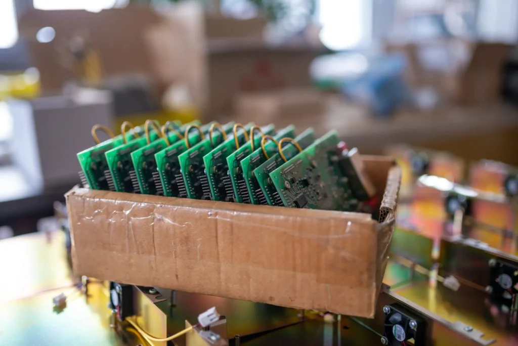 Electronic chips and TFT displays in cardboard box representing Techbros’ secure and sustainable electronics recycling in Scottsdale