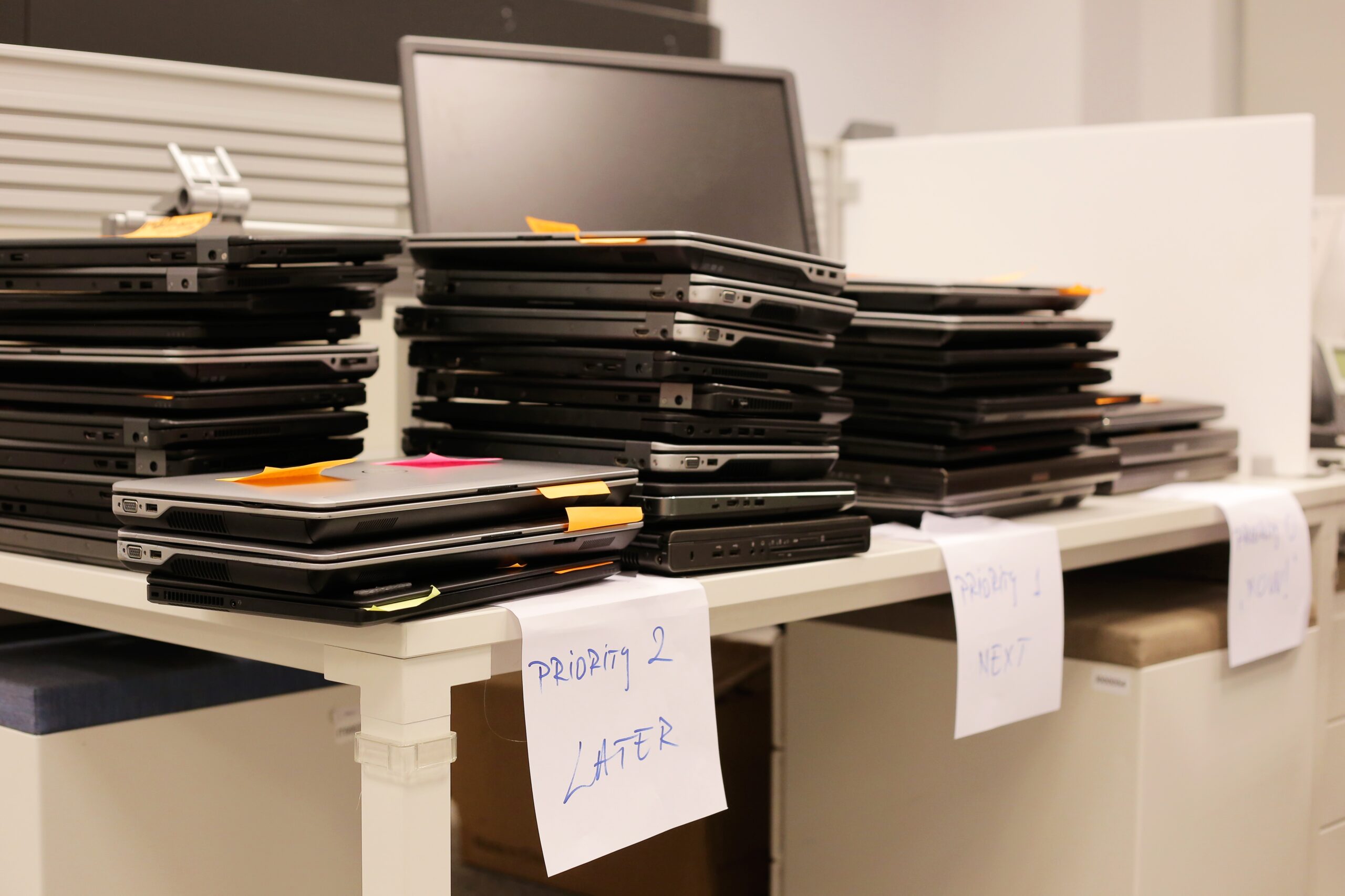 Stack of broken computers waiting to be fixed
